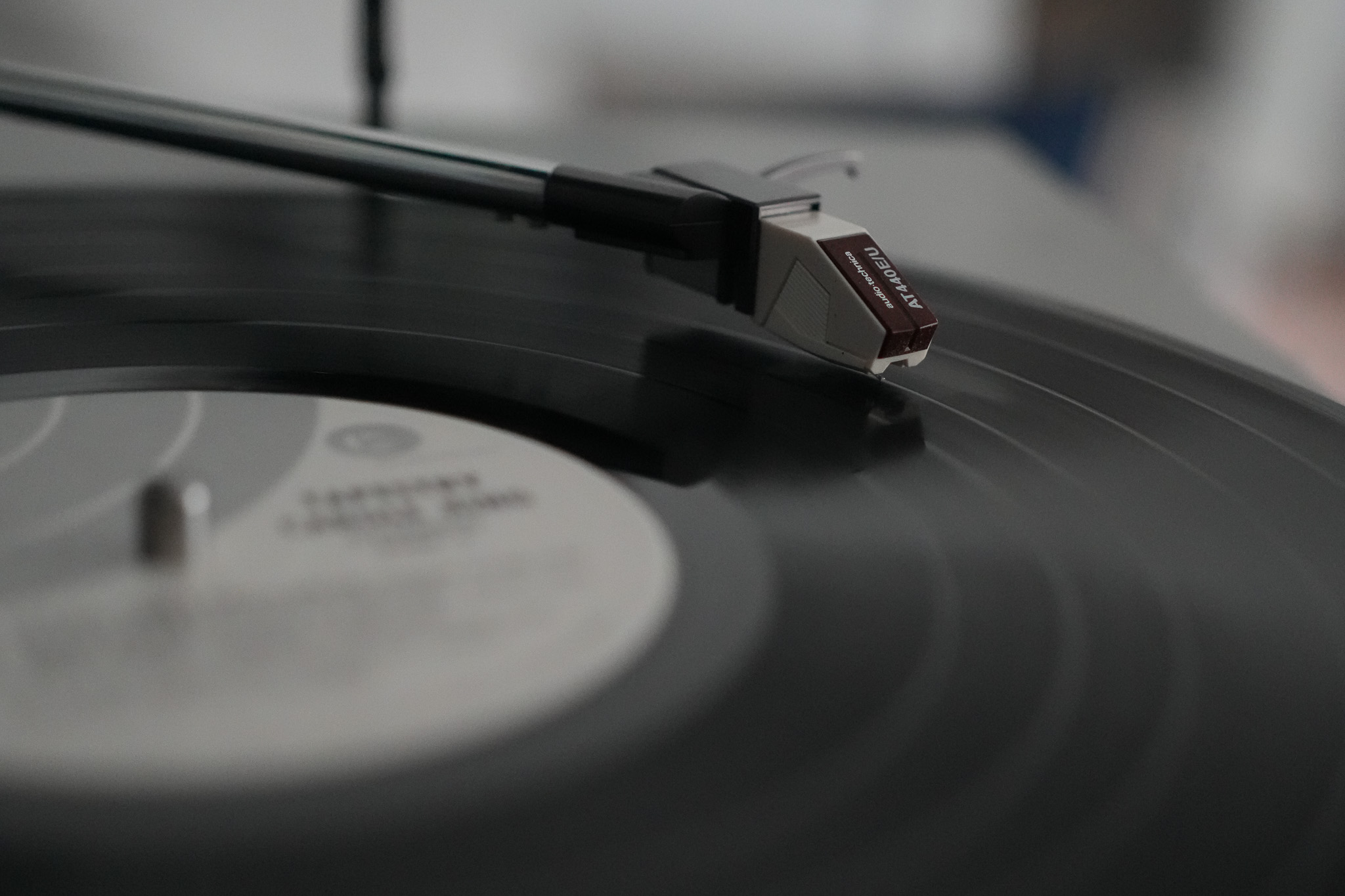 Record playing on a record player with the needle dropped, close image with blurred background